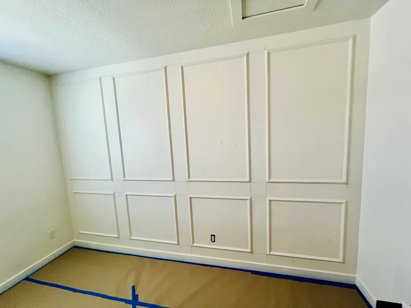 White picture frame molding on a wall during finishing
