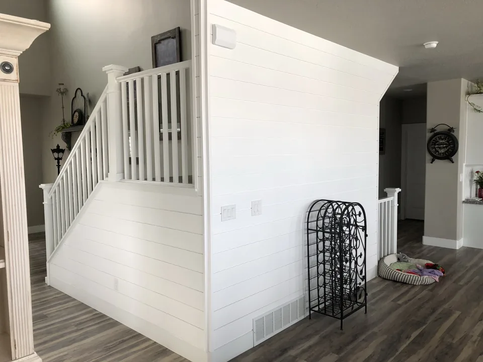 White shiplap wrapping a stairwell wall