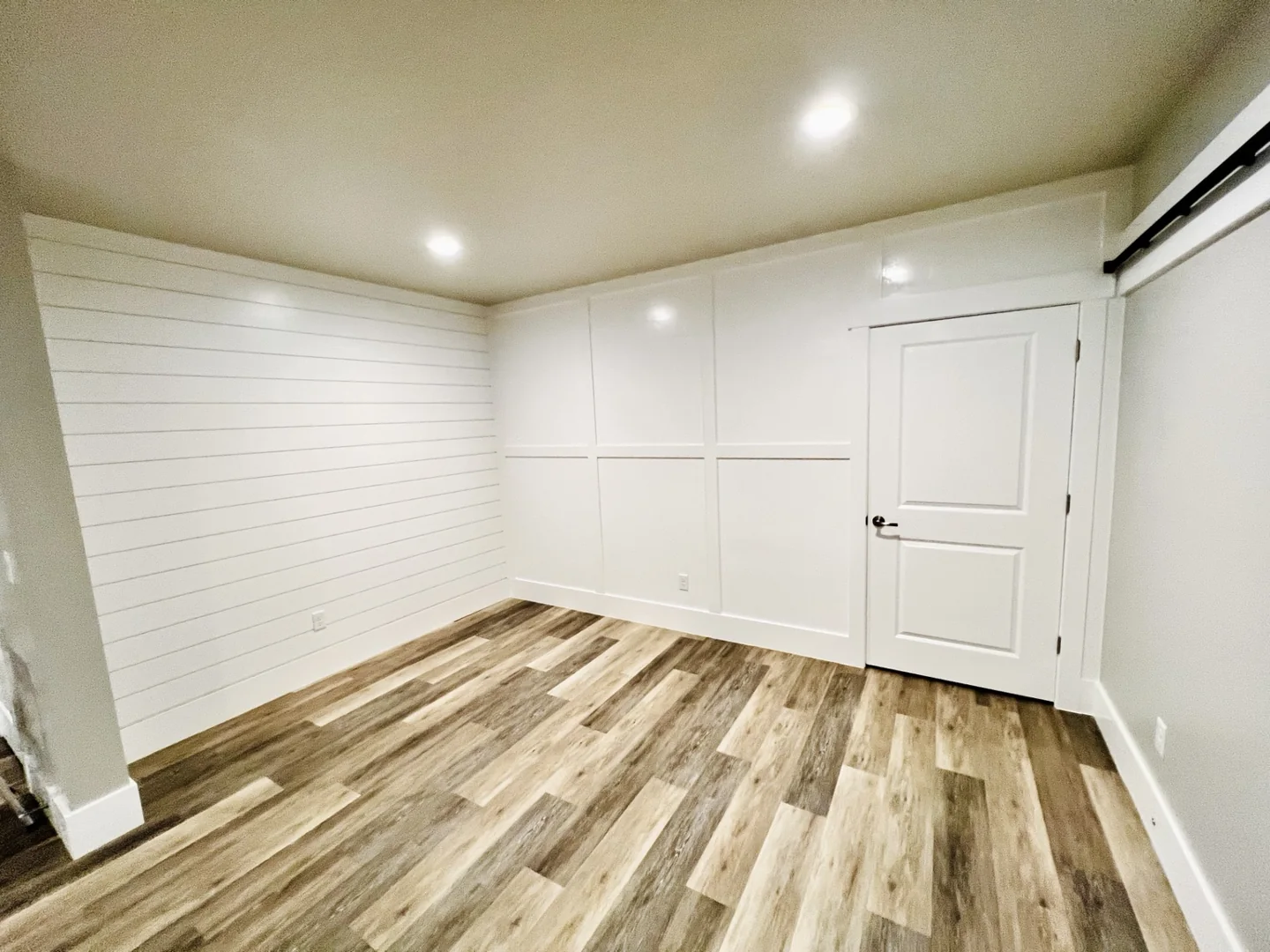 White horizontal shiplap and board and batten walls in a finished room